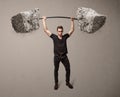 Muscular man lifting large rock stone weights Royalty Free Stock Photo