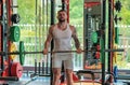 Muscular man lifting weights at gym. Handsome guy prepare to do exercises with dumbbell. Royalty Free Stock Photo