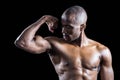 Muscular man looking at bicep while flexing muscles Royalty Free Stock Photo