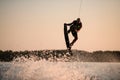 muscular man making trick in jump time with wakeboard against the backdrop of the sky Royalty Free Stock Photo