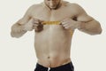 Muscular man measuring his chest. Royalty Free Stock Photo