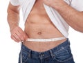 Muscular man measuring waist Royalty Free Stock Photo