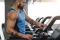 Muscular man in modern wireless headphones running Royalty Free Stock Photo