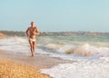 Muscular man and ocean Royalty Free Stock Photo