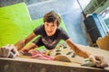 Muscular man practicing rock-climbing on a rock wall indoors Royalty Free Stock Photo