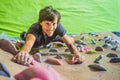 Muscular man practicing rock-climbing on a rock wall indoors Royalty Free Stock Photo