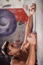 Muscular man practicing rock-climbing Royalty Free Stock Photo