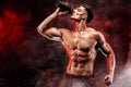 Muscular man with protein drink in shaker