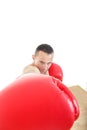 Muscular man with red gloves hiting to camera