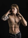 Muscular man shirtless listening to music on headphones Royalty Free Stock Photo