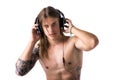 Muscular man shirtless, listening to music on headphones Royalty Free Stock Photo