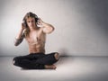 Muscular man shirtless listening to music on headphones Royalty Free Stock Photo