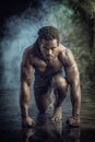 Muscular man shirtless, ready to sprint and run Royalty Free Stock Photo