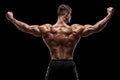 Muscular man showing back muscles, isolated on black background. Strong male rear view Royalty Free Stock Photo