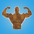 Muscular man showing biceps on blue. Silhouette of sportsman made with amino acids powder