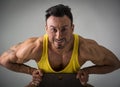 Muscular man sitting on chair and smiling Royalty Free Stock Photo