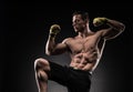 Muscular man in studio on dark background