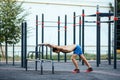 Muscular man warming up before exercise at crossfit ground doing push ups as part of training. Sport concept Royalty Free Stock Photo