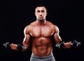 Muscular man working out with dumbbells Royalty Free Stock Photo