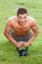 Muscular man working out on green grass Royalty Free Stock Photo
