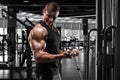 Muscular man working out in gym doing exercise for biceps, strong male bodybuilder Royalty Free Stock Photo
