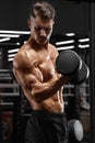 Muscular man working out in gym doing exercise for biceps, strong male bodybuilder Royalty Free Stock Photo