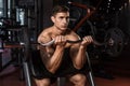 Muscular man working out in gym doing exercises with barbell Royalty Free Stock Photo