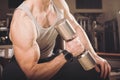 Muscular man working out in gym doing exercises with dumbbells at biceps Royalty Free Stock Photo