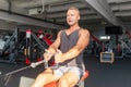 Muscular man working out in gym doing exercises,Exercise for triceps in the gym. strong male naked torso abs Royalty Free Stock Photo