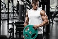 Muscular man working out in gym doing exercisess, strong male bodybuilder Royalty Free Stock Photo