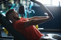 Muscular man working out hard at gym. Machine exercises. Chest workouts Royalty Free Stock Photo