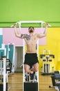 Muscular man workout doing pull ups on bar in gym,Man working out in a fitness club Royalty Free Stock Photo