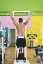 Muscular man workout doing pull ups on bar in gym,Man working out in a fitness club Royalty Free Stock Photo