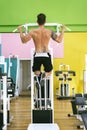 Muscular man workout doing pull ups on bar in gym,Man working out in a fitness club Royalty Free Stock Photo