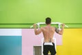 Muscular man workout doing pull ups on bar in gym,Man working out in a fitness club Royalty Free Stock Photo