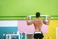 Muscular man workout doing pull ups on bar in gym,Man working out in a fitness club Royalty Free Stock Photo