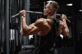 Muscular man workout in gym, doing exercise for back lat pulldown. Strong male rear view Royalty Free Stock Photo