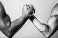 Muscular men measuring forces, arms. Hand wrestling, compete. Hands or arms of man. Muscular hand. Two men arm wrestling