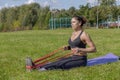 woman does seated row exercise outdoor