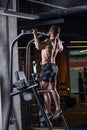 Muscular sexy young man doing exercise for the back on horizontal bar Royalty Free Stock Photo