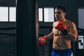 Male boxer in red gloves doing cardio boxing workout with punching bag Royalty Free Stock Photo