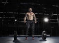 Muscular shirtless man concentrating before the barbell workout.