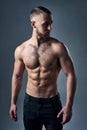 Muscular shirtless man standing with hands in pockets Royalty Free Stock Photo