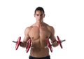 Muscular shirtless young man exercising biceps with dumbbells