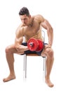 Muscular shirtless young man exercising biceps Royalty Free Stock Photo