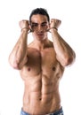 Muscular shirtless young man with handcuffs