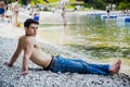 Muscular shirtless young man on lake in a sunny Royalty Free Stock Photo