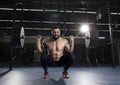 Muscular sportsman doing the squat exercise in the gym.Functiona