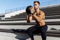 Muscular sporty man doing exercises with a ball, fitness with a ball outdoors Royalty Free Stock Photo