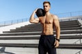 Muscular sporty man doing exercises with a ball, fitness with a ball outdoors Royalty Free Stock Photo